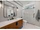 Updated bathroom features a vanity with dark fixtures and a walk-in shower at 11602 Innfields Dr, Odessa, FL 33556