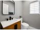 Updated half bathroom featuring modern vanity, black fixtures, and neutral paint colors at 11602 Innfields Dr, Odessa, FL 33556