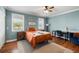 Comfortable bedroom featuring stylish decor, a ceiling fan, and two windows for ample natural light at 11602 Innfields Dr, Odessa, FL 33556