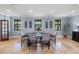 Formal dining room with a large table, seating for six, and natural light, perfect for Gathering gatherings at 11602 Innfields Dr, Odessa, FL 33556