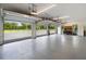 Spacious garage with overhead lighting and multiple garage doors with workspace and cabinets at 11602 Innfields Dr, Odessa, FL 33556