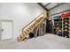 Garage featuring a staircase leading to storage, with appliances and shelving visible at 11602 Innfields Dr, Odessa, FL 33556