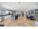 Spacious kitchen and dining area with stone floors, stainless appliances, and abundant natural light at 11602 Innfields Dr, Odessa, FL 33556