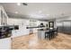 Modern kitchen with granite countertops, stainless steel appliances, and an island with barstool seating at 11602 Innfields Dr, Odessa, FL 33556