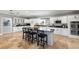 Contemporary kitchen featuring white cabinets, granite countertops, and a center island with bar seating at 11602 Innfields Dr, Odessa, FL 33556