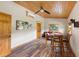 Cozy living area featuring wood-look floors, comfortable seating, and natural light from the windows at 11602 Innfields Dr, Odessa, FL 33556
