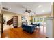 View of the living room with hardwood floors, a fireplace, and french doors leading to the pool at 11602 Innfields Dr, Odessa, FL 33556