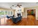 View of the living room with hardwood floors, a fireplace, and french doors leading to the pool at 11602 Innfields Dr, Odessa, FL 33556