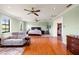 Spacious bedroom with hardwood floors, ample natural light, ceiling fans, and an adjacent walk-in closet offers comfort at 11602 Innfields Dr, Odessa, FL 33556