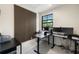 Modern office space with multiple monitors, sleek black desks, and accent wood wall at 11602 Innfields Dr, Odessa, FL 33556
