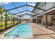 Enclosed pool with clear blue water and view of the surrounding property at 11602 Innfields Dr, Odessa, FL 33556