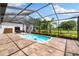 Enclosed pool area with beautiful landscaping and views of the property at 11602 Innfields Dr, Odessa, FL 33556