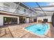 Enclosed pool area with brick patio and second-story balcony, perfect for relaxing outdoors at 11602 Innfields Dr, Odessa, FL 33556