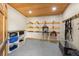 Well-organized tack room with saddle racks, shelving units, and equipment storage for equestrian supplies at 11602 Innfields Dr, Odessa, FL 33556