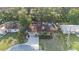 Aerial view of the house in a tree-covered neighborhood at 1513 Owen Dr, Clearwater, FL 33759
