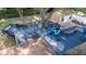 Aerial view of a wooden back deck with a hot tub, seating, and easy access to the home and backyard at 1513 Owen Dr, Clearwater, FL 33759
