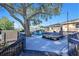 Expansive wooden back deck with a hot tub, comfortable seating, and string lights for cozy outdoor evenings at 1513 Owen Dr, Clearwater, FL 33759