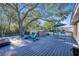 Outdoor deck featuring a hot tub, seating, mature trees, and backyard views at 1513 Owen Dr, Clearwater, FL 33759