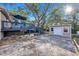 Landscaped backyard with a wooden deck, storage shed, and plenty of space for outdoor activities and entertaining at 1513 Owen Dr, Clearwater, FL 33759