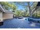 Outdoor deck featuring a hot tub, and backyard views through mature trees at 1513 Owen Dr, Clearwater, FL 33759