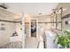 Bathroom featuring a double vanity, tile walls, and glass block partition at 1513 Owen Dr, Clearwater, FL 33759