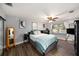 Bedroom boasts wood floors, a ceiling fan, natural light, and relaxing decor at 1513 Owen Dr, Clearwater, FL 33759