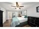 Comfortable bedroom featuring a ceiling fan, wood floors, and relaxing colors at 1513 Owen Dr, Clearwater, FL 33759