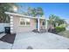 Charming single-story home exterior with a bright blue front door, well-maintained landscaping, and a welcoming entrance at 1513 Owen Dr, Clearwater, FL 33759