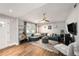 Cozy living room featuring a comfortable sectional sofa, modern decor, and hardwood floors at 1513 Owen Dr, Clearwater, FL 33759
