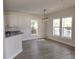 Bright dining room with modern chandelier, wood-look flooring and large windows overlooking the outdoors at 1537 Palmetto St, Clearwater, FL 33755