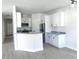 Modern kitchen with white cabinets, stainless steel appliances, granite countertops, and light wood-look floors at 1537 Palmetto St, Clearwater, FL 33755