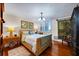 Comfortable bedroom with wicker frame, plantation shutters, and wood flooring at 1600 Gulf Blvd # 618, Clearwater, FL 33767