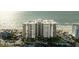 Stunning aerial view of oceanfront condo building with beach access and palm trees at 1600 Gulf Blvd # 618, Clearwater, FL 33767