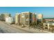 Beautiful condo building on the beach with a pool surrounded by palm trees at 1600 Gulf Blvd # 618, Clearwater, FL 33767