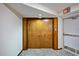Hallway with neutral carpet and wooden doors leading to the unit, featuring an exit sign at 1600 Gulf Blvd # 618, Clearwater, FL 33767