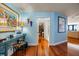 Bright hallway featuring hardwood flooring, decorative art, and leads to multiple rooms at 1600 Gulf Blvd # 618, Clearwater, FL 33767