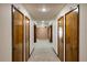 Hallway featuring wood doors and neutral patterned carpet in a well-lit building at 1600 Gulf Blvd # 618, Clearwater, FL 33767