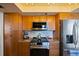 The kitchen has stainless steel appliances, granite countertops, and wooden cabinetry at 1600 Gulf Blvd # 618, Clearwater, FL 33767