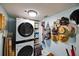 Contemporary laundry room features stacked washer/dryer with storage and accessories at 1600 Gulf Blvd # 618, Clearwater, FL 33767