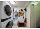 Contemporary laundry room features stacked washer/dryer and storage at 1600 Gulf Blvd # 618, Clearwater, FL 33767