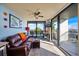 Cozy living room with a leather couch, balcony access, and scenic views of the water at 1600 Gulf Blvd # 618, Clearwater, FL 33767