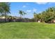 Spacious backyard with lush green grass and a wooden fence offering privacy at 1608 Ledgestone Dr, Brandon, FL 33511