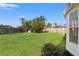 Large private backyard features lush green grass, a wooded fence, and a serene landscape at 1608 Ledgestone Dr, Brandon, FL 33511