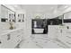 Bright bathroom with dual vanities, soaking tub with black marble accent wall, and natural light at 1608 Ledgestone Dr, Brandon, FL 33511