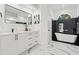 Modern bathroom showcases a freestanding tub, sleek fixtures, and stylish black and white accents at 1608 Ledgestone Dr, Brandon, FL 33511