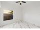 Bright bedroom with window, ceiling fan, and marble flooring at 1608 Ledgestone Dr, Brandon, FL 33511