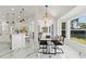 Bright dining area with modern black dining table, kitchen views, and large windows providing natural light at 1608 Ledgestone Dr, Brandon, FL 33511