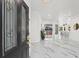 Bright foyer featuring a view of the open floor plan, including the modern kitchen and access to the lanai at 1608 Ledgestone Dr, Brandon, FL 33511
