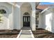 Elegant entrance featuring a black front door with glass inserts and a white arched entryway at 1608 Ledgestone Dr, Brandon, FL 33511
