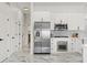 Modern kitchen boasts stainless steel appliances, white cabinets, and marble floors, creating a sleek design at 1608 Ledgestone Dr, Brandon, FL 33511